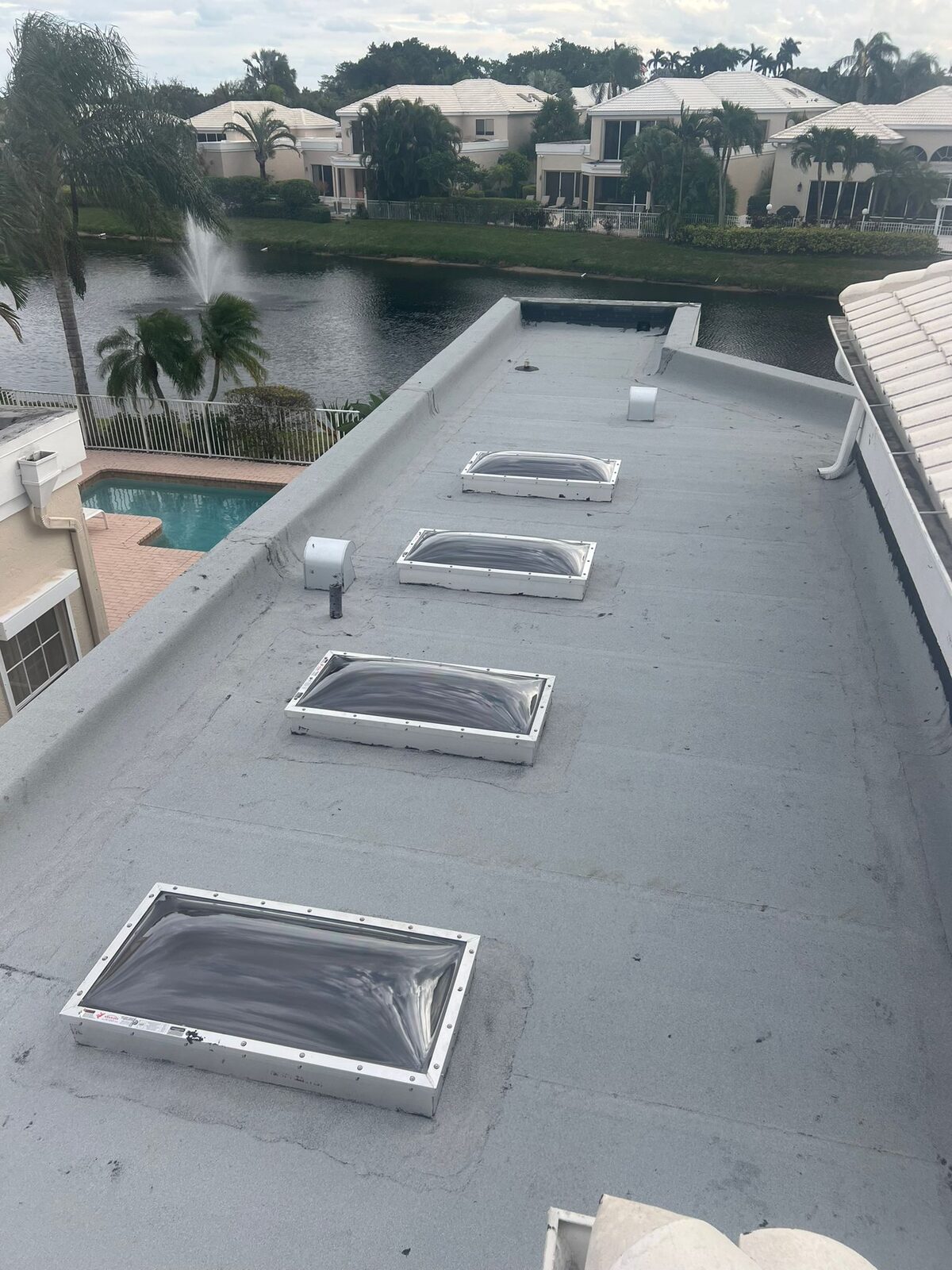 Completed low-slope roof with skylights on a South Florida property.